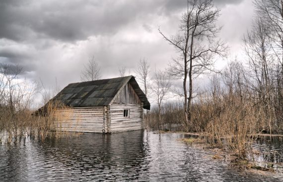 old wooden house in water