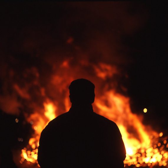 Man standing next to fire