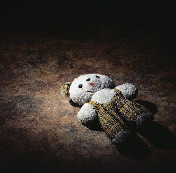 Old teddy bear on floor