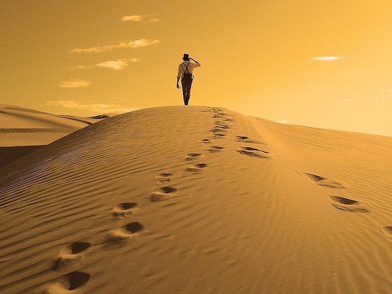 a-man-walking-in-desert-wallpaper-56218