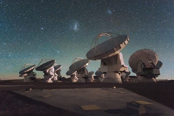 800px The Atacama Large Millimeter Array ALMA by night under the Magellanic Clouds 570x379
