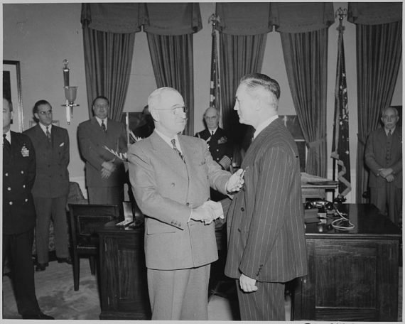 750px President Truman presents a Medal of Merit to Secretary of Defense James Forrestal in the Oval Office    NARA   199640 570x456